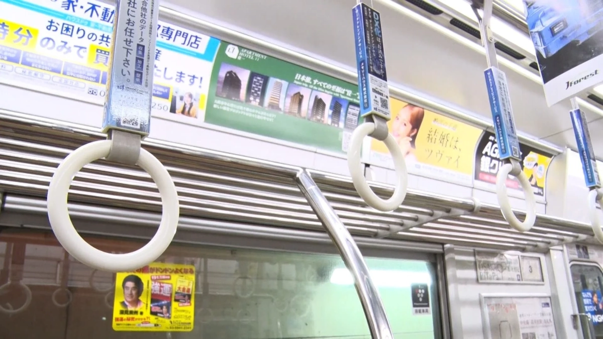 電車内の丸型吊り革と広告