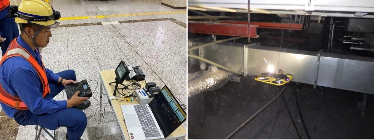 作業員がコントローラーとラップトップを使ってドローンを操作し、暗く狭い空間にあるダクトや配管をドローンで点検している様子